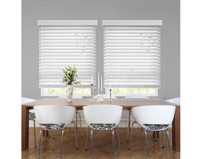 White custom blinds installed above a dining table